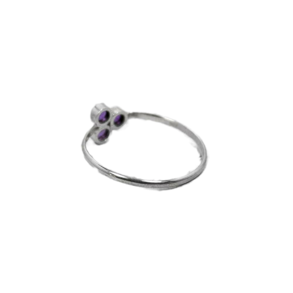 Silver ring with purple gemstones on a white background