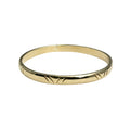 Gold ring with a textured band on a white background