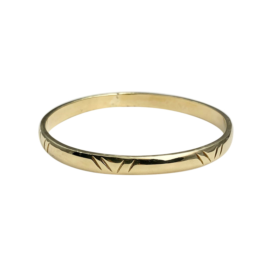 Gold ring with a textured band on a white background