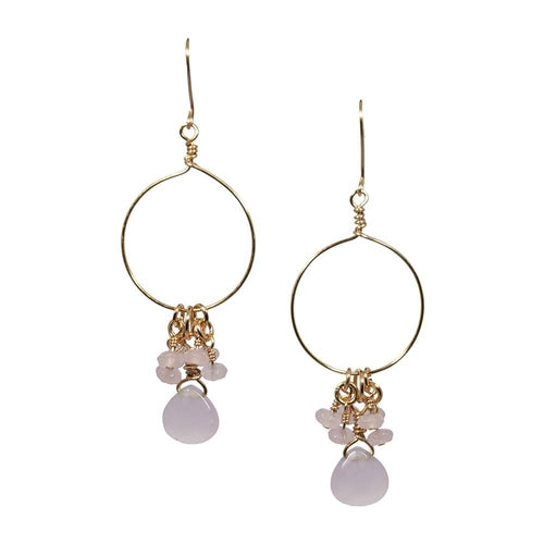 Gold hoop earrings with pink stones on a white background
