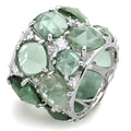 Ring with green gemstones and silver accents on a white background